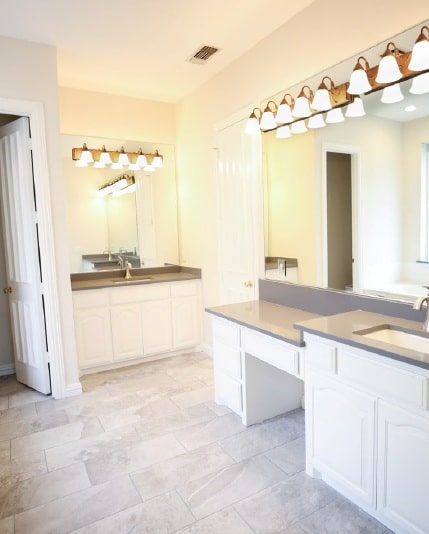 Bathroom remodel with light grey large-format tile and double vanity